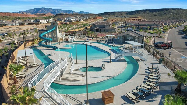 Un complexe hôtelier doté d’une grande piscine, d’un toboggan aquatique et offrant une vue sur les montagnes.