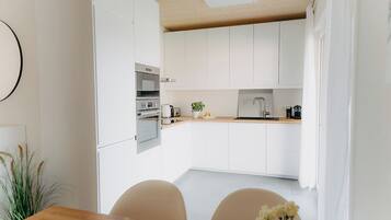 Deluxe Chalet, Garden View | Private kitchen | Electric kettle, high chair