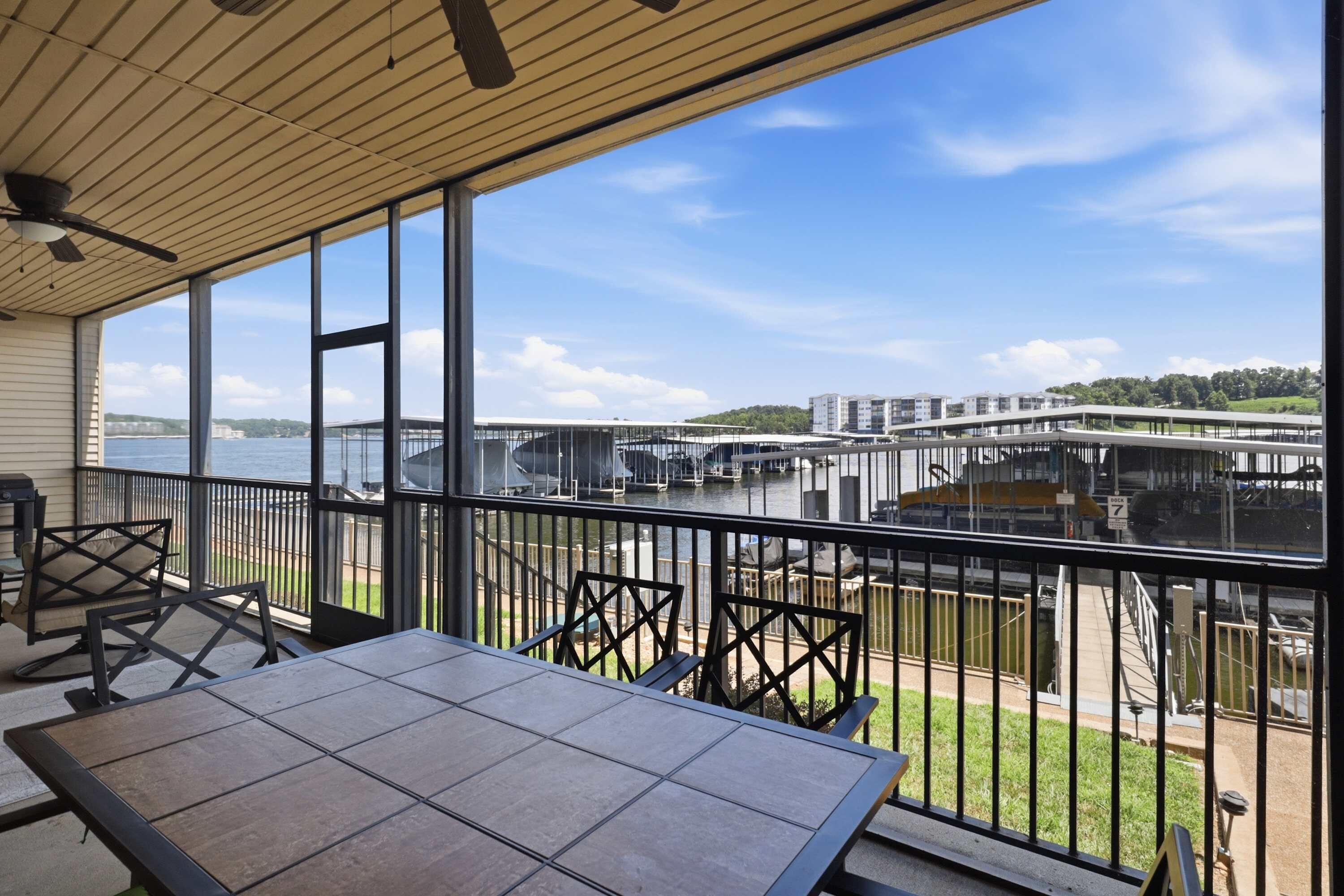 A balcony with a view of a marina and a bridge.