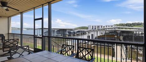 A balcony with a view of a marina and a bridge.