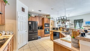 A modern kitchen with wooden cabinets, stainless steel appliances, and a central island.