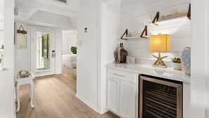 A modern kitchen with white cabinetry, a built-in oven, and decorative items on the countertop. - Bay & Sunset Views I 6-Seat Golf Cart I Sleeps 8 (Miramar Beach)