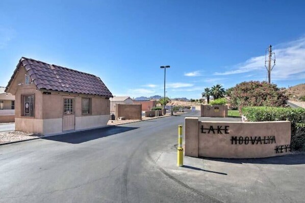 A residential area with a house, a sign reading "LAKE MOOVALYA KEYS", and a clear sky. - The Gentleman's Jack, Moovalya Keys Value (Parker)