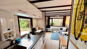 A compact kitchen with a sink, stove, and dining area.