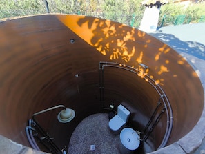 A cylindrical structure with a toilet and sink inside, surrounded by a metal frame. - 'Finca Verónica' with Sea View, Wi-Fi and Air Conditioning (Candelaria)