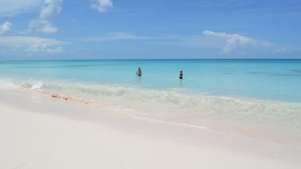 A beach with clear turquoise water and a sandy shore. - Indigo 2br 2 Bedroom Home (Governor's Harbour)