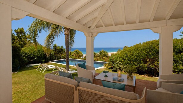 A covered patio with outdoor furniture, a pool, and a view of the ocean. - Recently renovated villa overlooking the coast of Atlanterra, for 8 pax. (Tarifa)