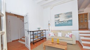 A living room with a sofa, a coffee table, and a bookshelf. - Recently renovated villa overlooking the coast of Atlanterra, for 8 pax. (Tarifa)