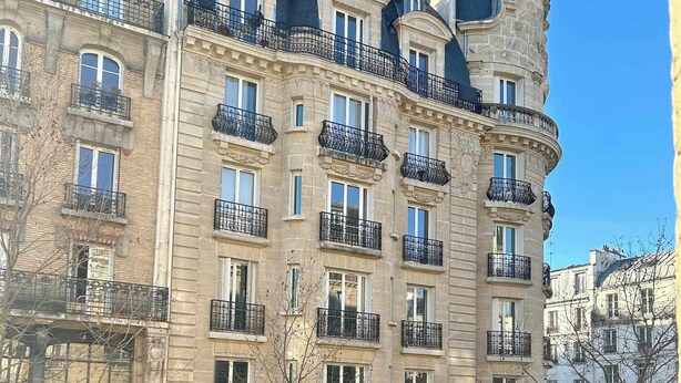 A multi-story building with a classic architectural style, featuring ornate balconies and large windows. - Carreau du Temple Marais CityCosy (Paris)