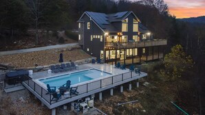 A two-story house with a swimming pool, outdoor seating, and a deck. - Van Kirk Cove 6 BDR Stunner! (Branson West)