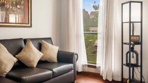 A room with a black leather sofa, white curtains, a framed picture, and a black bookshelf with a sign that says "HOPE". - Banta House Retreat at the Pointe (Branson)