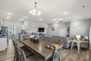 Cozy living space with a central dining area, sofa, and television.