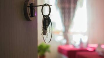 A key hanging on a door lock.
