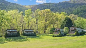 A property with three cabins, each with a deck and surrounded by lush greenery and trees. - Afton Mountain Vineyards (Afton)