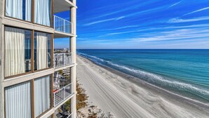 A beachfront hotel with multiple balconies overlooking the ocean. - One Ocean Place 1105- Three Bedroom, Three Bath Oceanfront Condo (Garden City Beach)