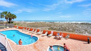 A swimming pool with lounge chairs and a view of the beach. - Seacrest 905 by Liquid Life (Gulf Shores)