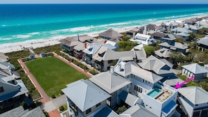 A coastal residential area with houses, a beach, and a clear view of the ocean. - Rosemary Beach Rooftop Heated Pool w/ Carriage House (Rosemary Beach)