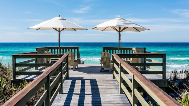 A wooden pier with two white umbrellas and chairs facing the ocean. - Rosemary Beach Rooftop Heated Pool w/ Carriage House (Rosemary Beach)