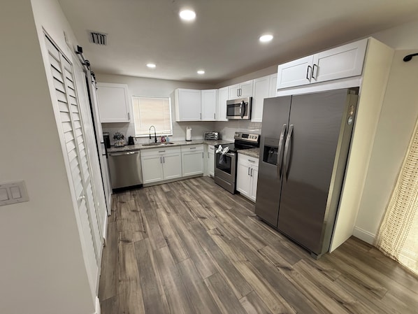 Enjoy cooking in this well-equipped kitchen with a refrigerator, microwave, and oven.