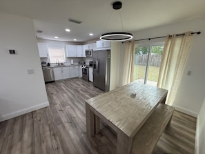Enjoy cooking in this well-equipped kitchen with a central island, sink, and stainless steel appliances.