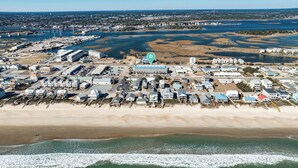 An aerial view of a coastal town with a marina, sandy beaches, and residential buildings. - Perfect Surf City Stay: Walk to Beach, Dining, & Fun (Surf City)