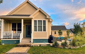 A single-story house with a front porch, a covered patio, and a well-maintained lawn. - The Sparrow - 32 Meadowview (Prince Edward)