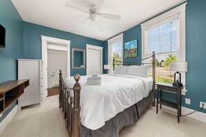 A bedroom with a bed, a nightstand, a ceiling fan, and a window with blinds. - The Sparrow - 32 Meadowview (Prince Edward)