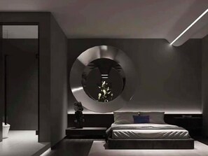 A modern bedroom with a circular mirror, a bed, and a nightstand. - Chongqing Jetbear Hotel (Chongqing)