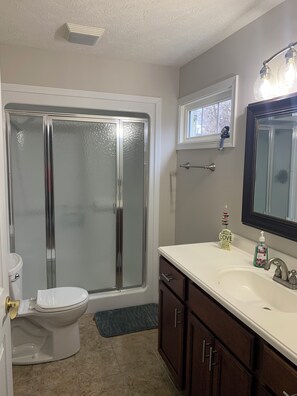 Shower, hair dryer, towels, toilet paper