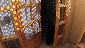 A wooden interior with a window and a ladder. - Sidi Kaouki Full Apartment Seafront  (Sidi Kaouki)