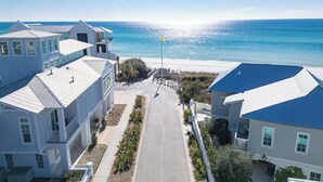 A coastal residential area with houses, a clear sky, and a beach in the background. - Southern Breeze | Easy Beach Access & Private Pool (Inlet Beach)