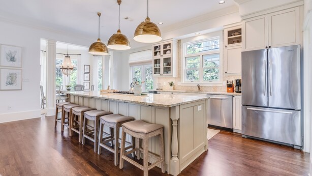 A spacious kitchen with a large island, bar stools, stainless steel appliances, and pendant lighting. - Southern Breeze | Easy Beach Access & Private Pool (Inlet Beach)