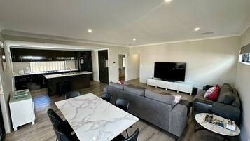 Un appartement moderne comprenant une cuisine, un coin repas et un salon.