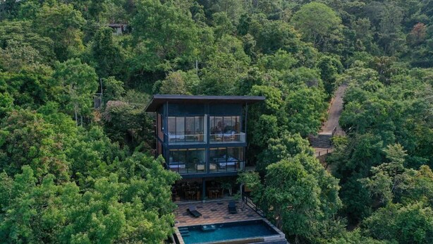 A modern two-story building with a swimming pool, surrounded by dense forest. - Nuga Retreat (Illagolla)