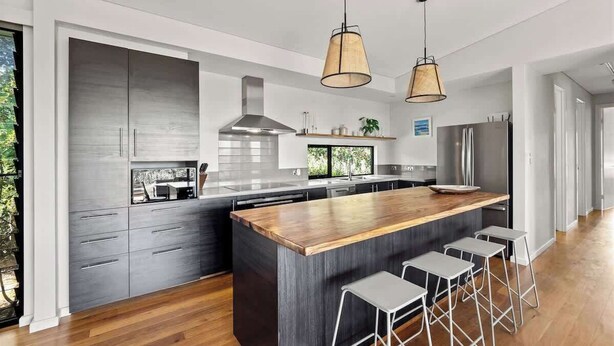 A modern kitchen with a large island, bar stools, and pendant lighting. - Wildflower Ridge: Elevated Forest & Coastal Escape (Western Australia)