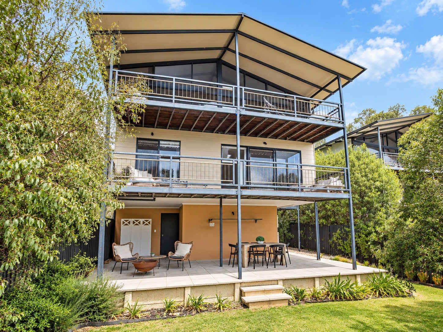 This unique home offers multi-level outdoor living with a spacious lower patio and covered balconies for enjoying the views.