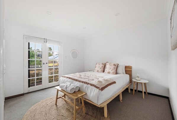 Sleep soundly in the third bedroom with a queen bed and enjoy direct access to the outdoors.