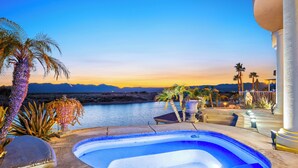 A swimming pool with a view of mountains and a body of water at sunset. - Paradise Riverfront Home with Spa and Dock Sleeps 16+ (Bullhead City)