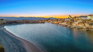 A riverside town with a beach, boats, and houses along the water. - Paradise Riverfront Home with Spa and Dock Sleeps 16+ (Bullhead City)