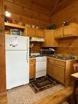 Fridge, microwave, stovetop, dining tables