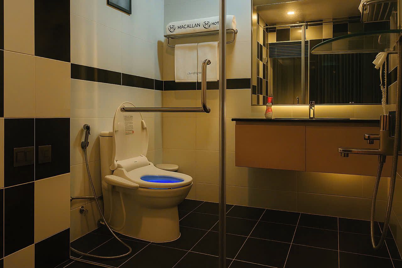 A bathroom with a toilet, a bidet, a shower, and a sink.