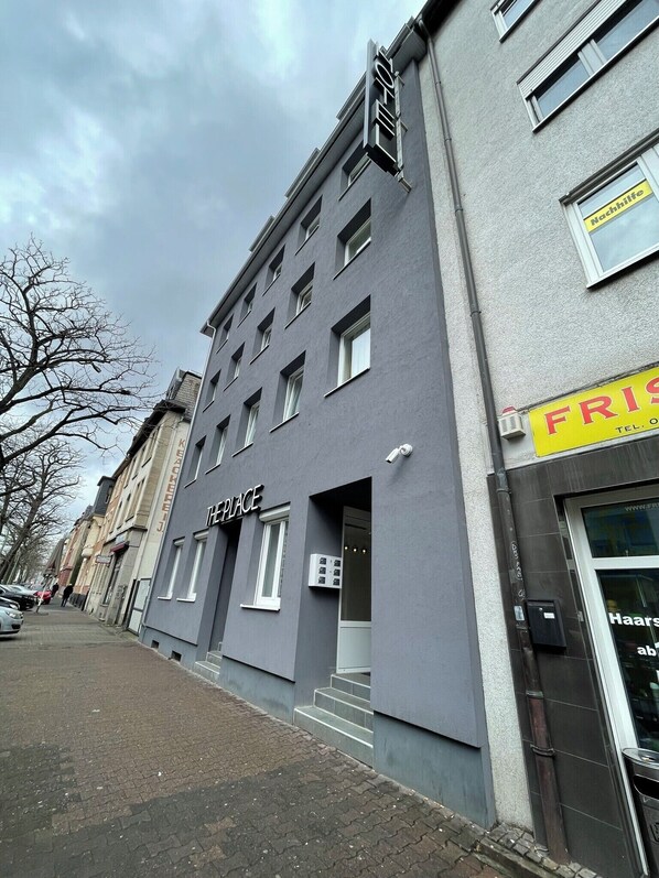 A building with a sign reading "THE PLACE" and a visible entrance. - THE PLACE HOTEL - Frankfurt City Messe (Frankfurt)