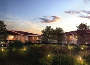 Hotel features a flat roof design with large windows and beautifully landscaped surroundings.