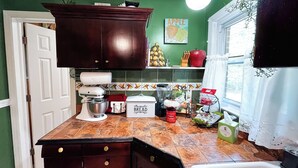 A kitchen with a mixer, a bread box, and a window with curtains. - Charming 1-bedroom apartment in fabulous Princeton with WiFi, AC (Princeton)