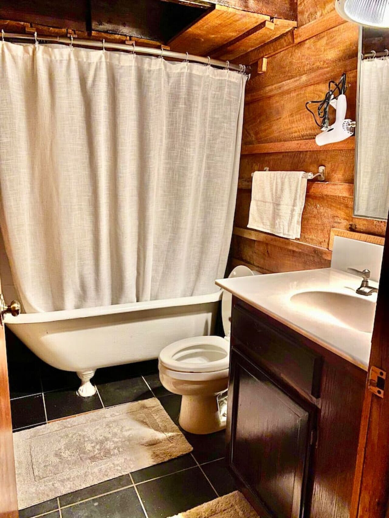A bathroom with a bathtub, toilet, and sink.