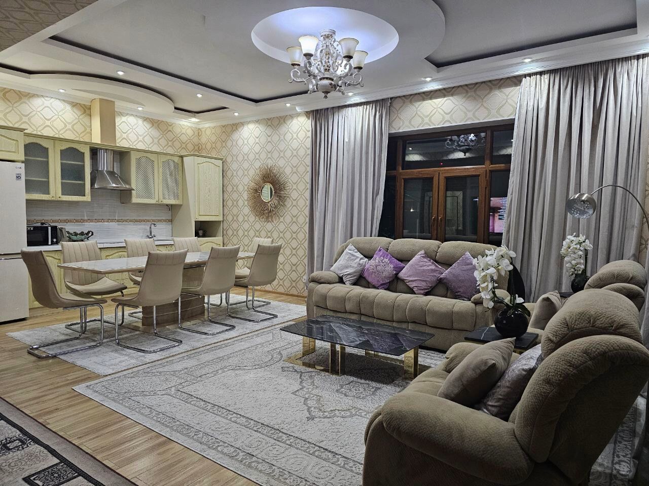 A living room with a sofa, coffee table, and dining area.