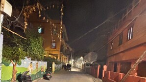 A narrow street at night with a motorcycle parked on the left. - Plush hotels (Bhubaneshwar)