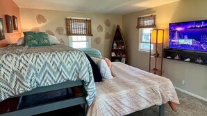 A bedroom with a bed, a TV, and a bookshelf. - Inground Pool w/ Fully fenced Yard/ Arcade/  6 beds incl Tri-Bunk/ Theatre  (Wyoming)