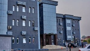 A modern building with a symmetrical facade, multiple windows, and decorative elements on the upper levels. - Hotel De Alommah Kubwa Abuja Nigeria (Abuja)