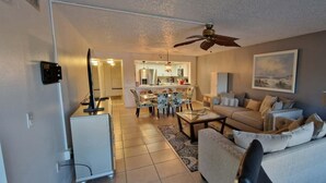 A living room with a sofa, coffee table, and chairs. There is a dining area with a table and chairs. A kitchen is visible in the background. - Literally 3 mins from Siesta with its number 1 beaches!!!!
Location! Location! (Sarasota)